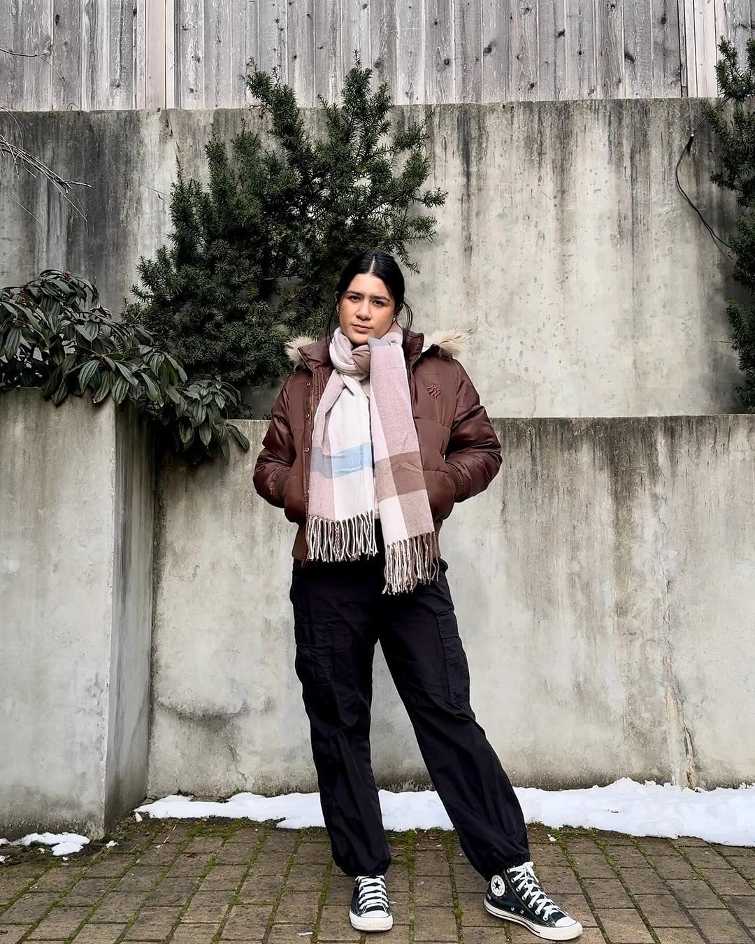 Brown jacket with checked scarf and black cargo pants
