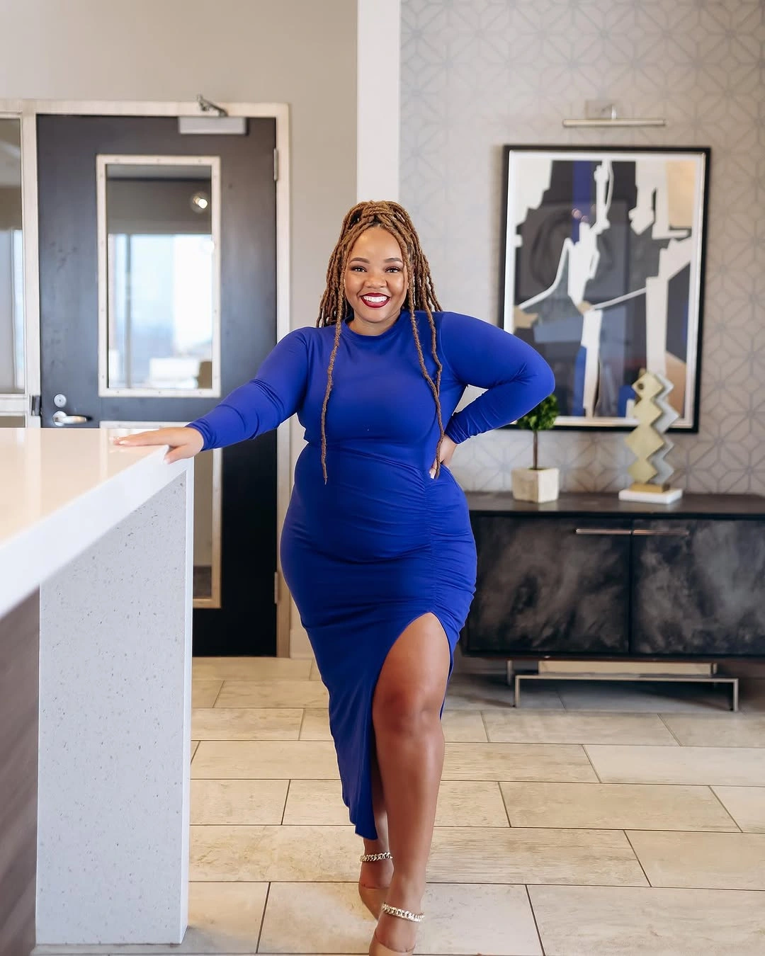 Cobalt long-sleeve dress with side slit and heels