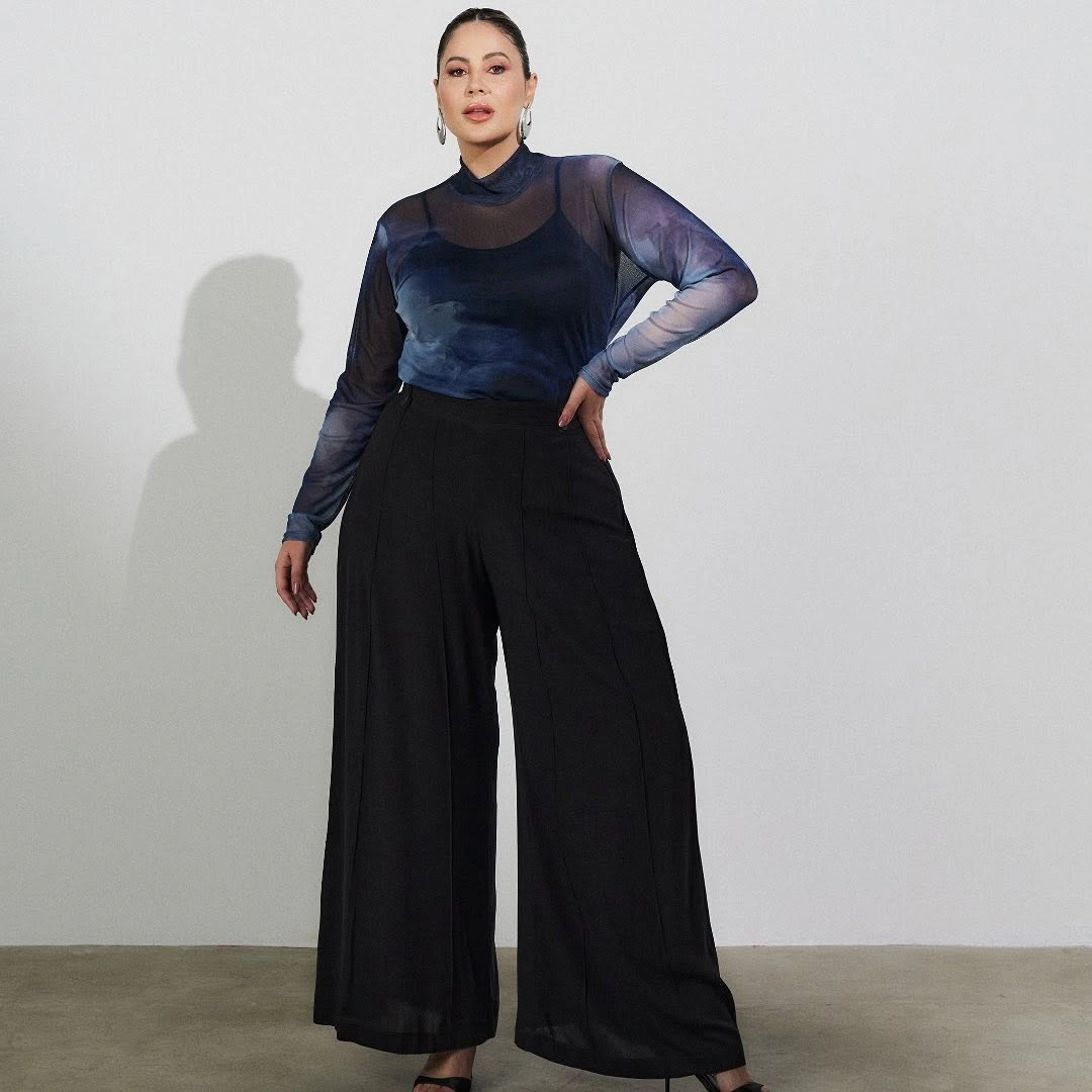 Sheer blue top with black wide-leg trousers
