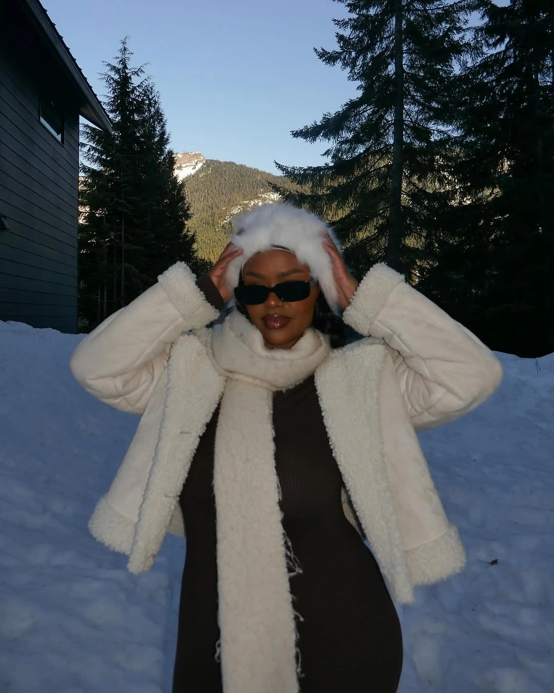 Fluffy white jacket and scarf over dark dress