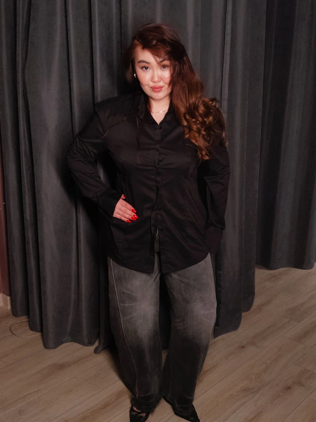 Black button-up shirt with washed gray jeans