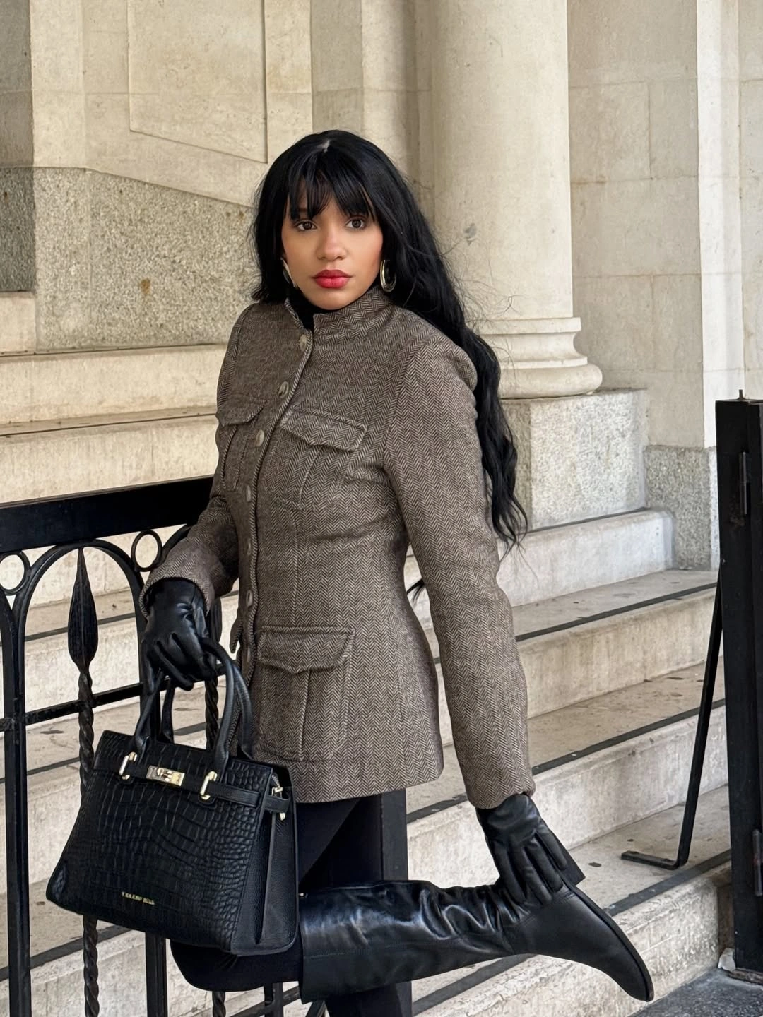 Grey tailored coat with black trousers, gloves, bag and boots