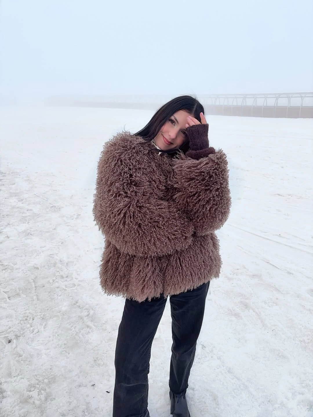Dusty brown shaggy jacket with black trousers and black boots