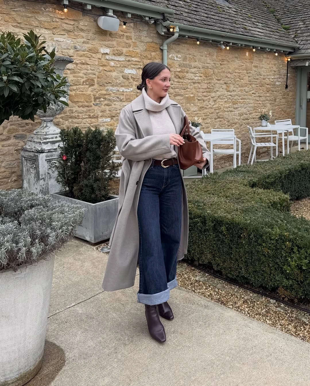 Light gray long coat with cuffed jeans brown boots and tote