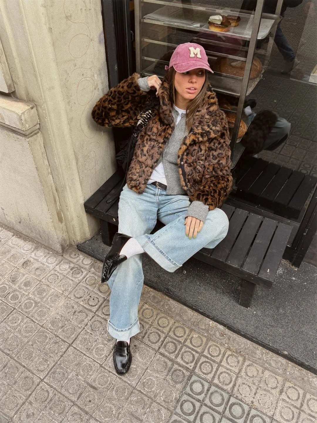 Spotted textured jacket with light jeans burgundy cap and loafers