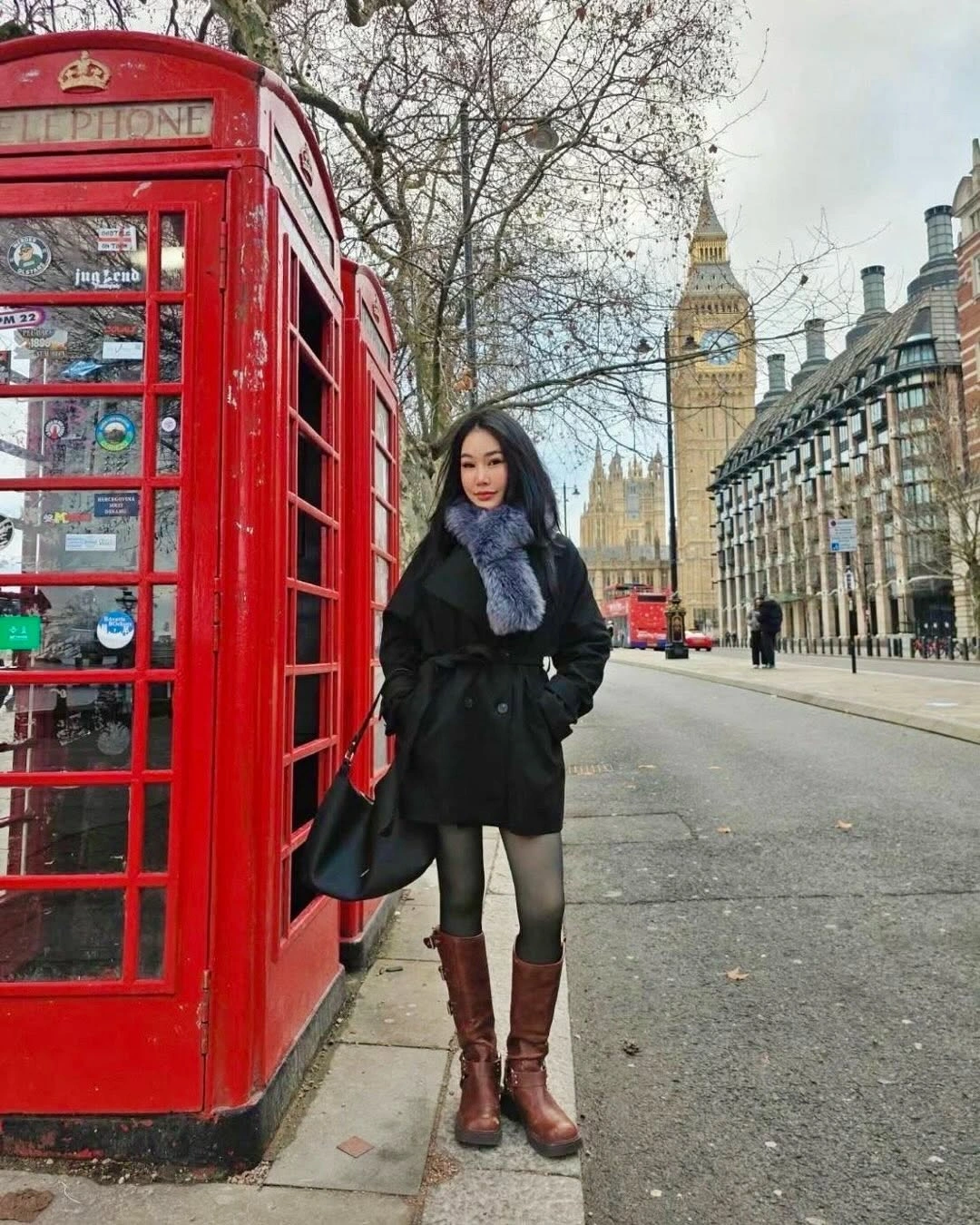 Black coat and navy scarf with tall brown leather boots