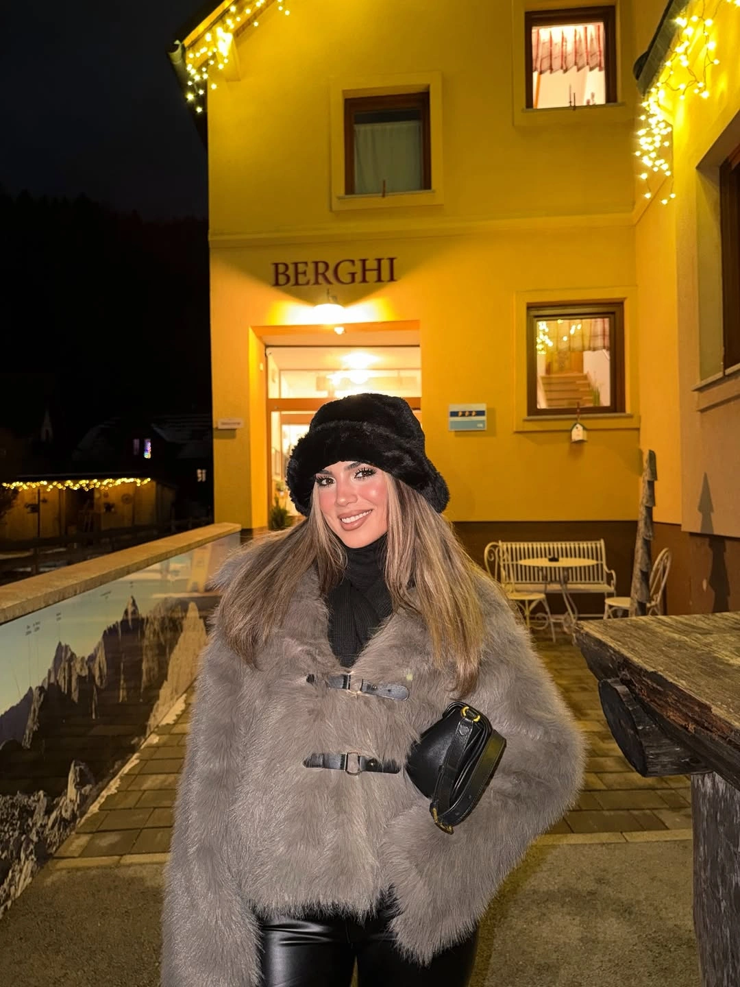 Black coat with wide gray scarf and brown boots