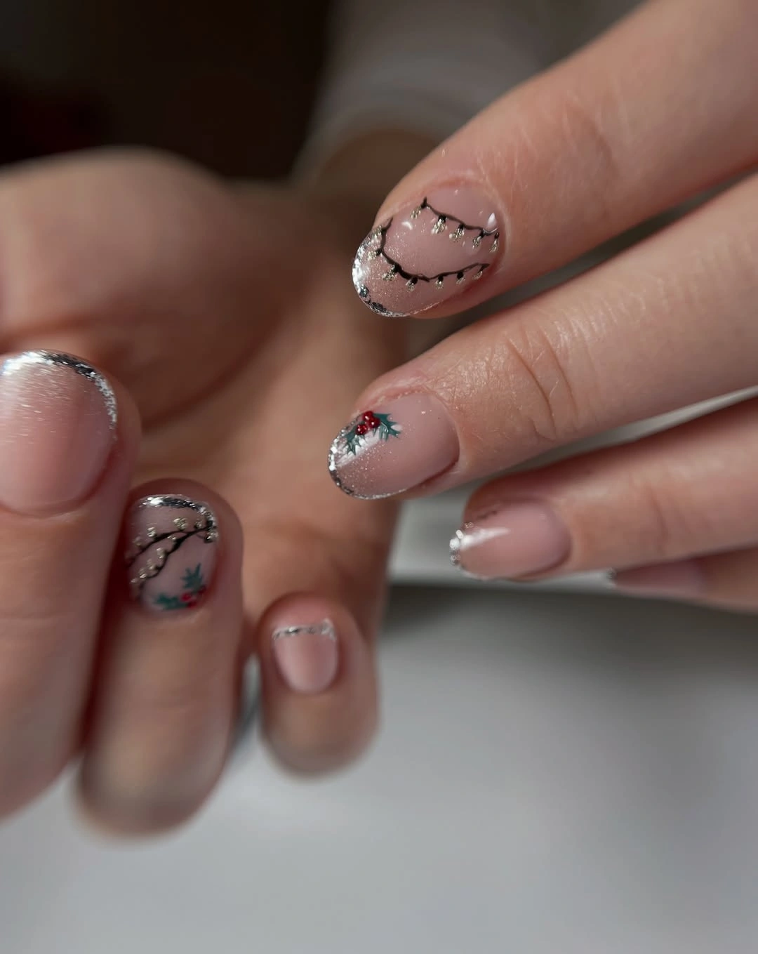 Sheer nude short nails with silver tips and fine black lines