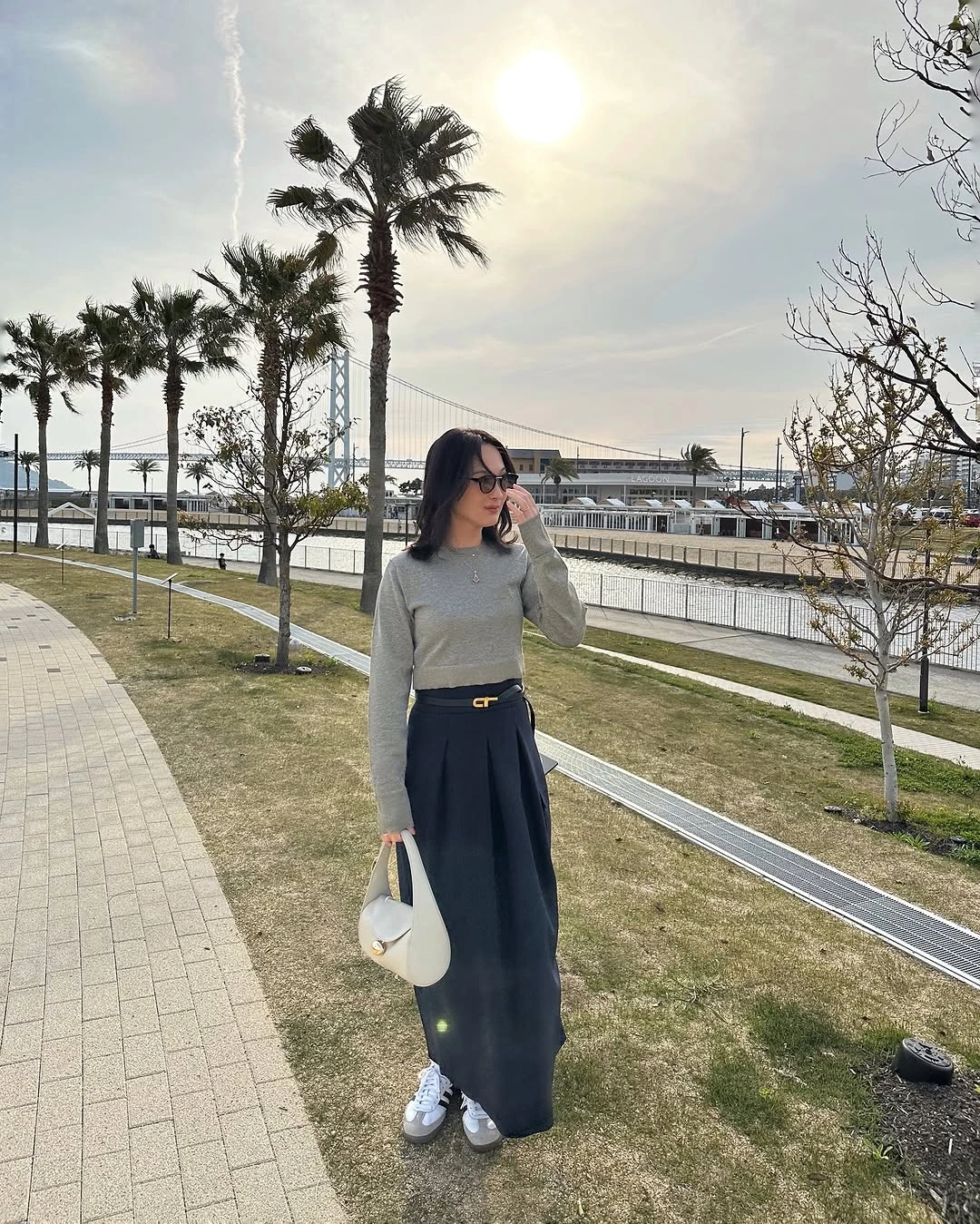 Cream turtleneck, full olive midi skirt, black belt, and fringed scarf