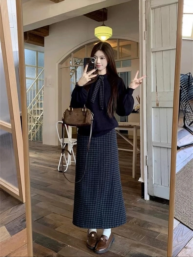 Black puffer, white maxi skirt, white sneakers, and pink ribbon