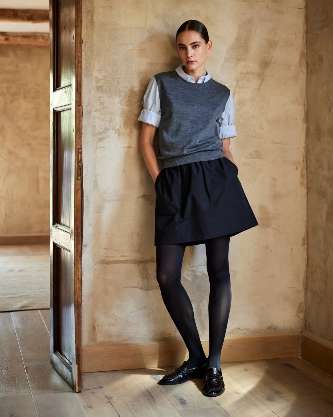 Navy upper layer, dark plaid skirt, gray socks, and loafers