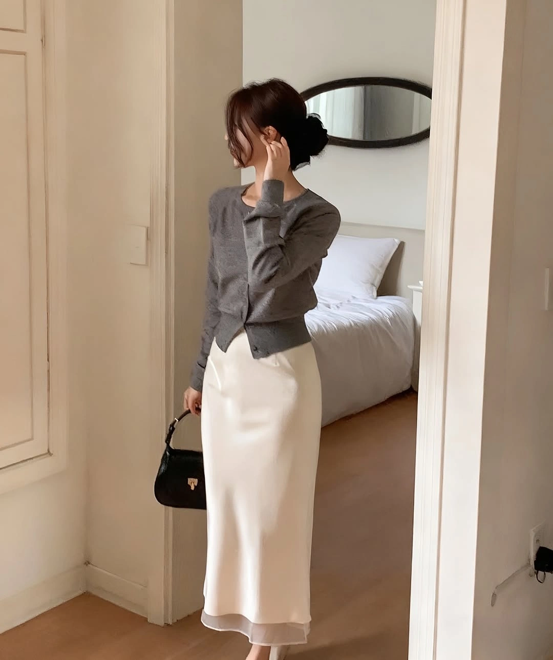 Gray sweater vest, striped shirt, navy skirt, tights, and loafers