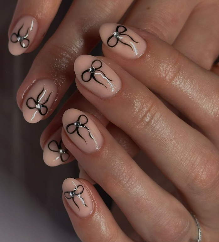Sheer Nude with Black Bow Accents — Winter Nails for Teens