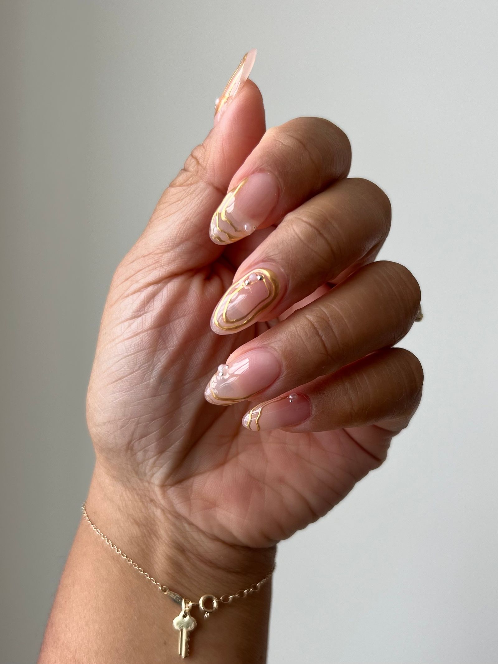 Long Oval Gold Swirl Nails — Winter Wedding Guest Nails
