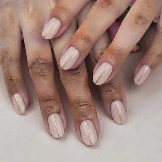 Both Hands Close-Up Pale Nude Gold Line Oval Nails Both Hands Close-Up Pale Nude Gold Line Oval Nails β Classy New Years Nails 2027