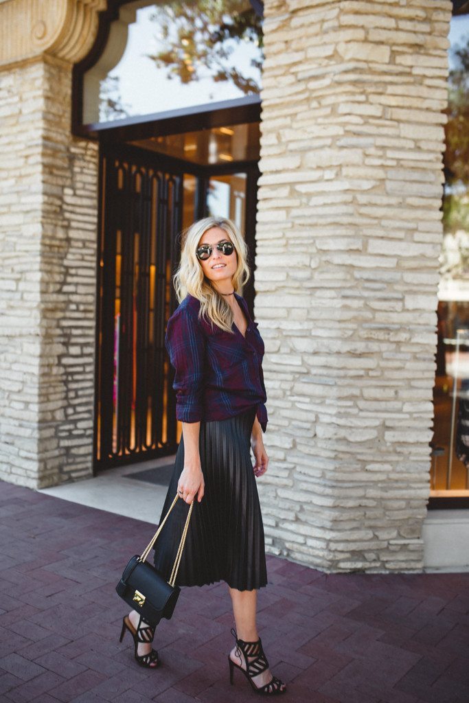 Black Pleated Faux Leather Midi Skirt with Tied Plaid Shirt — Leather Skirt Outfits
