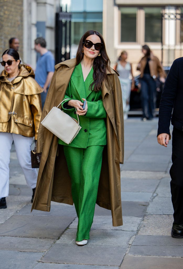 Vibrant Green Suit Layered Under a Trench Coat — Winter Wedding Guest Outfits