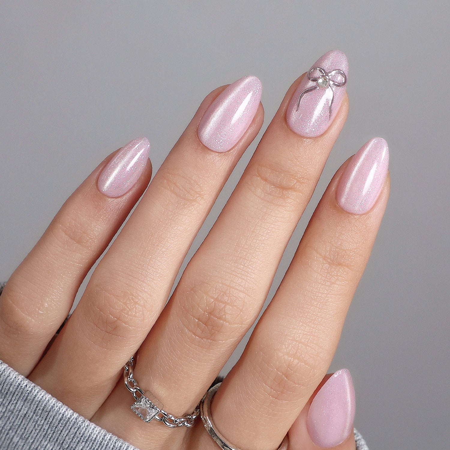 Pale Pink Shimmer with 3D Silver Bow Accent Pale Pink Shimmer with 3D Silver Bow Accent β Winter Bow Nails
