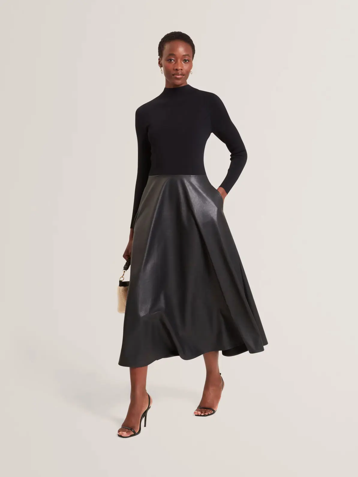 Faux Leather Midi Skirt Paired with Mock Neck Top — Winter Wedding Guest Outfits