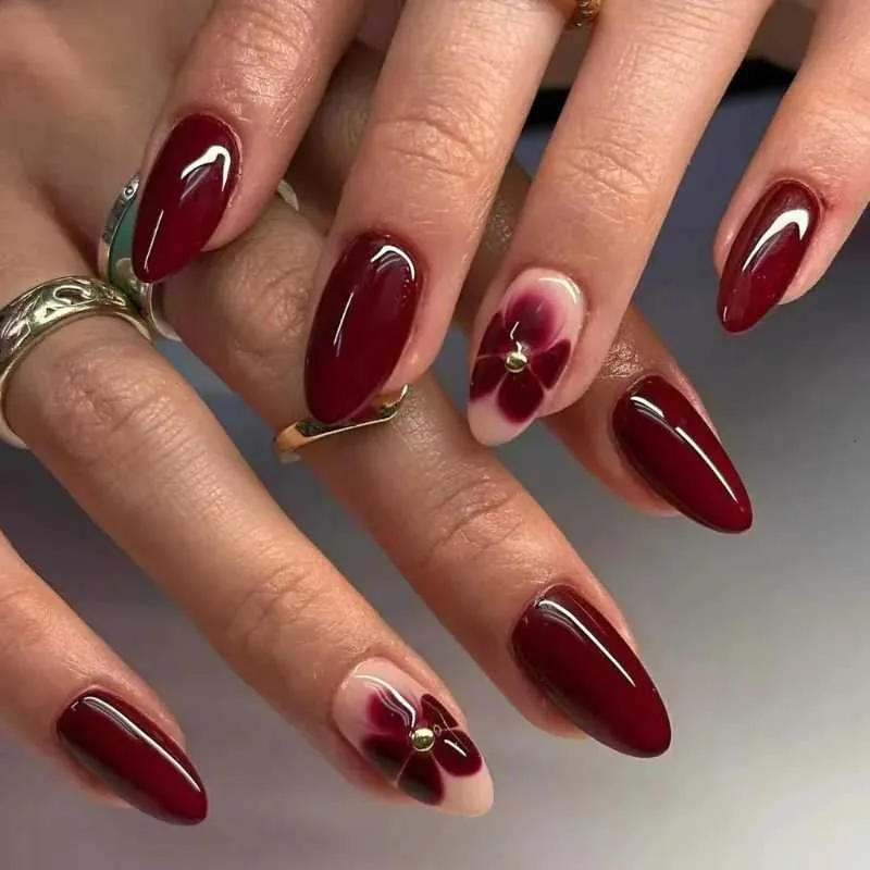 Deep Red with Floral Nude Accents Deep Red with Floral Nude Accents β New Years Almond Nails 2027
