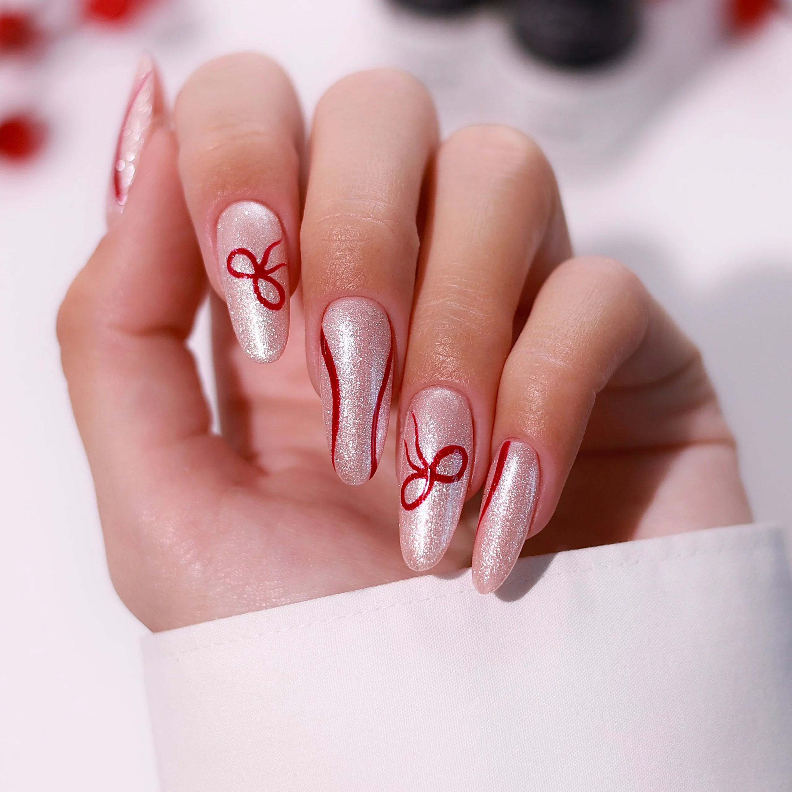 Champagne Shimmer Almond Nails with Red Bows Champagne Shimmer Almond Nails with Red Bows β Subtle Christmas Nails 2026
