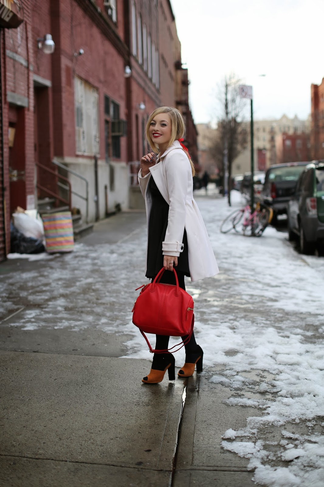 White Wool Coat Over Black Dress with Red Handbag Accent White Wool Coat Over Black Dress with Red Handbag Accent β Nashville Winter Outfits