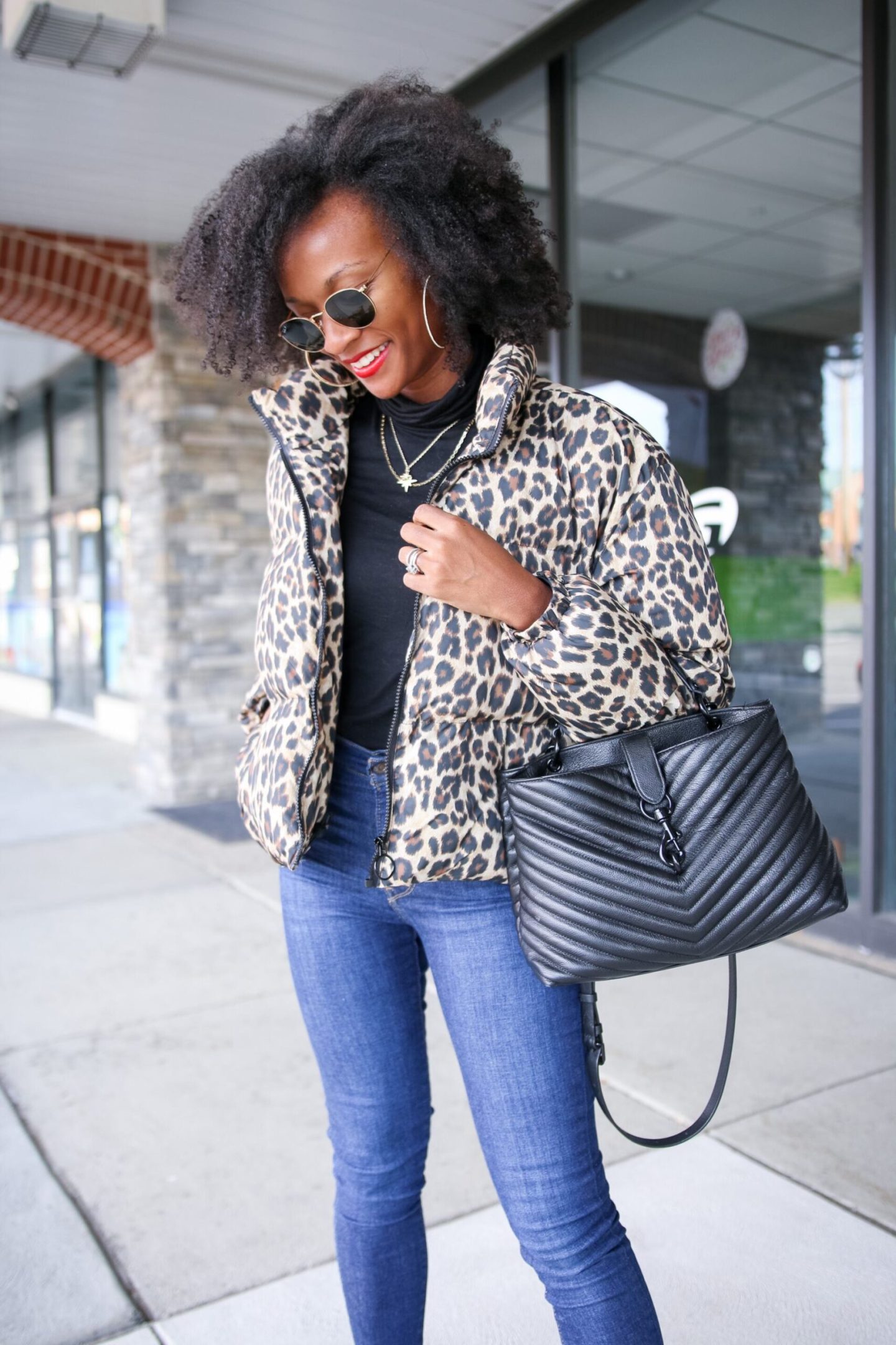 Leopard Print Puffer Jacket Over Black Turtleneck And Blue Jeans Leopard Print Puffer Jacket Over Black Turtleneck And Blue Jeans β Leopard Coat Outfits
