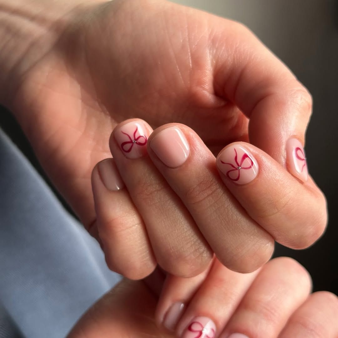 Nude Pink Glossy Red Bow Nails Nude Pink Glossy Red Bow Nails β Simple Christmas Nails 2026