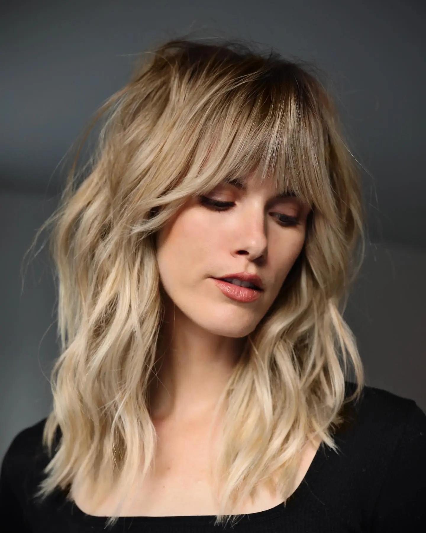 Shag with Collarbone Layers and Curtain Bangs — Winter Haircuts for Wavy Hair