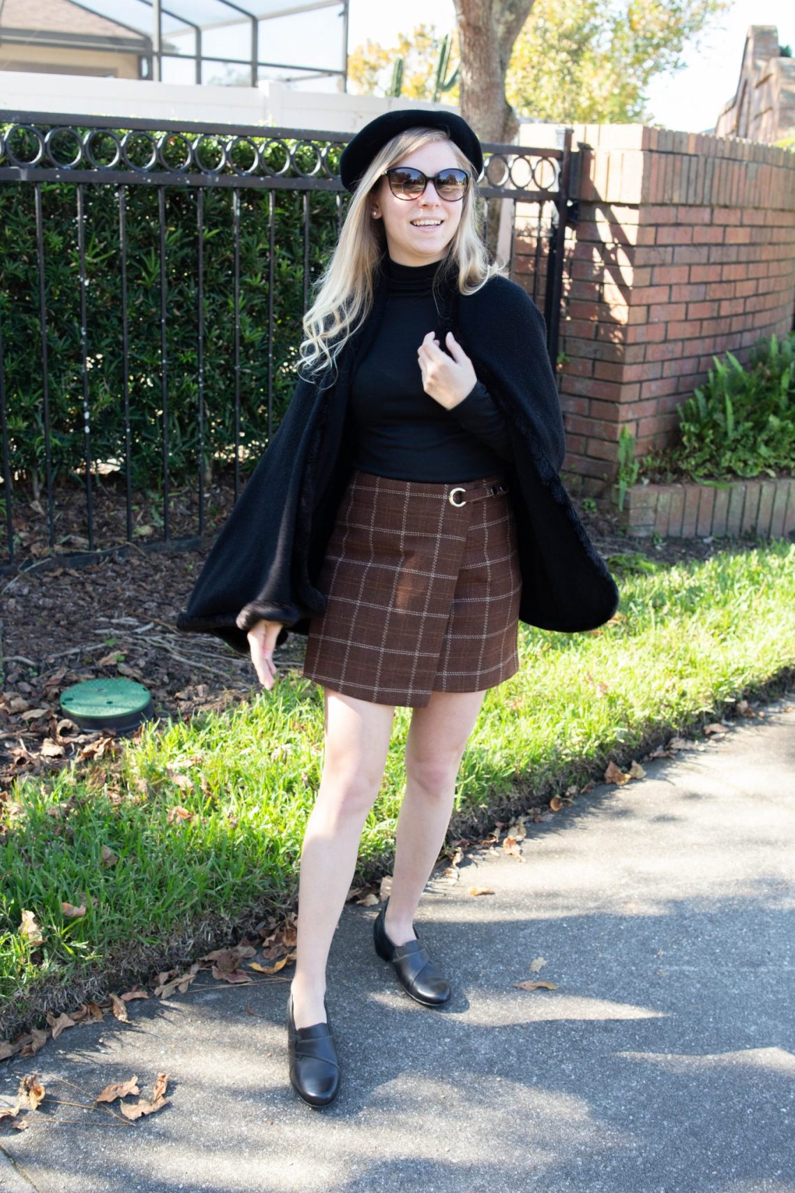 Black Cape and Plaid Wrap Skirt for a Chic December Look — December Outfits