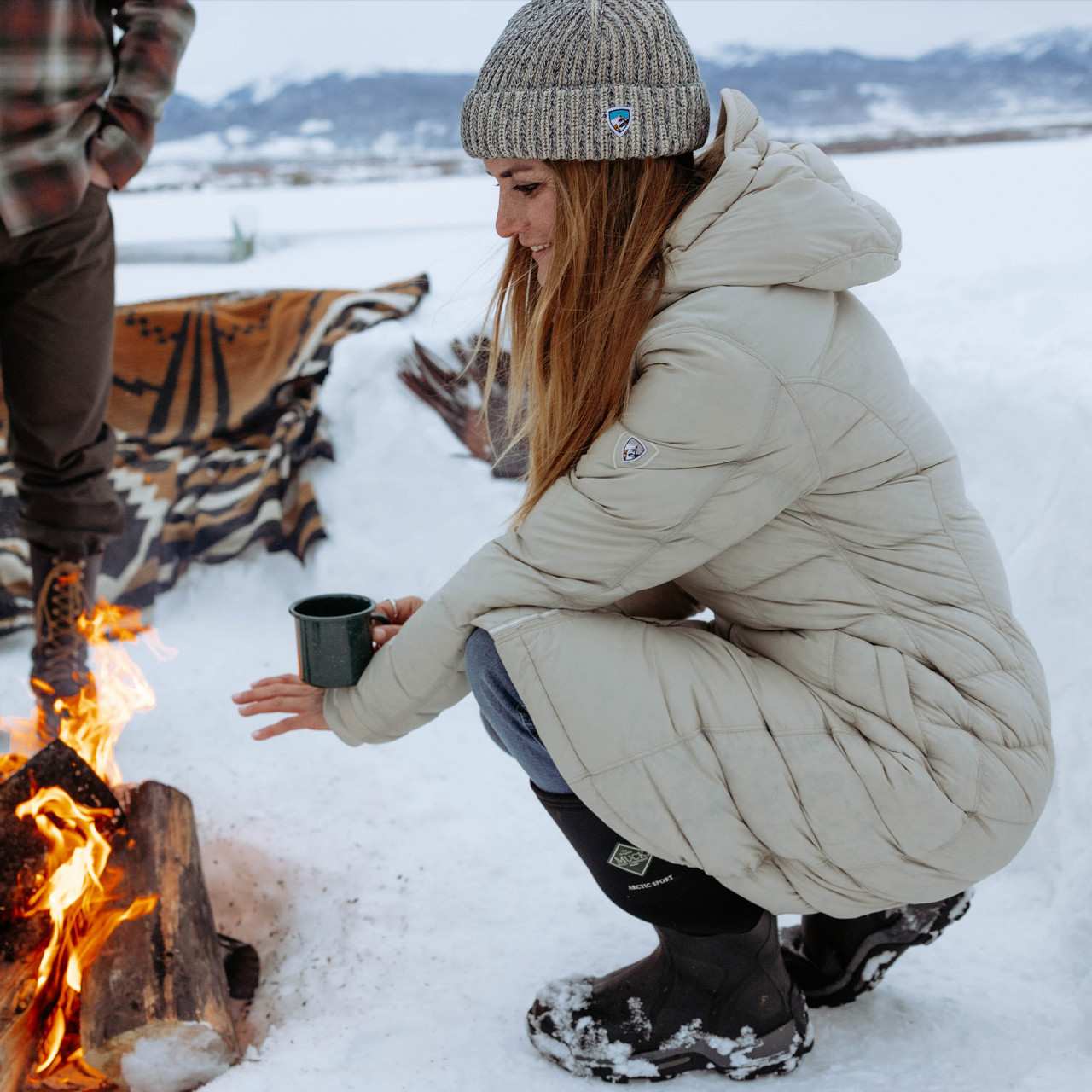 Beige Puffer Coat by Campfire in Snow Beige Puffer Coat by Campfire in Snow β Winter Hiking Outfits