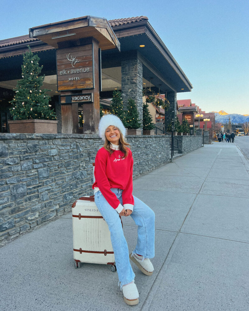 Playful Red Sweatshirt and Jeans for a Winter Holiday Trip — Winter Travel Outfits