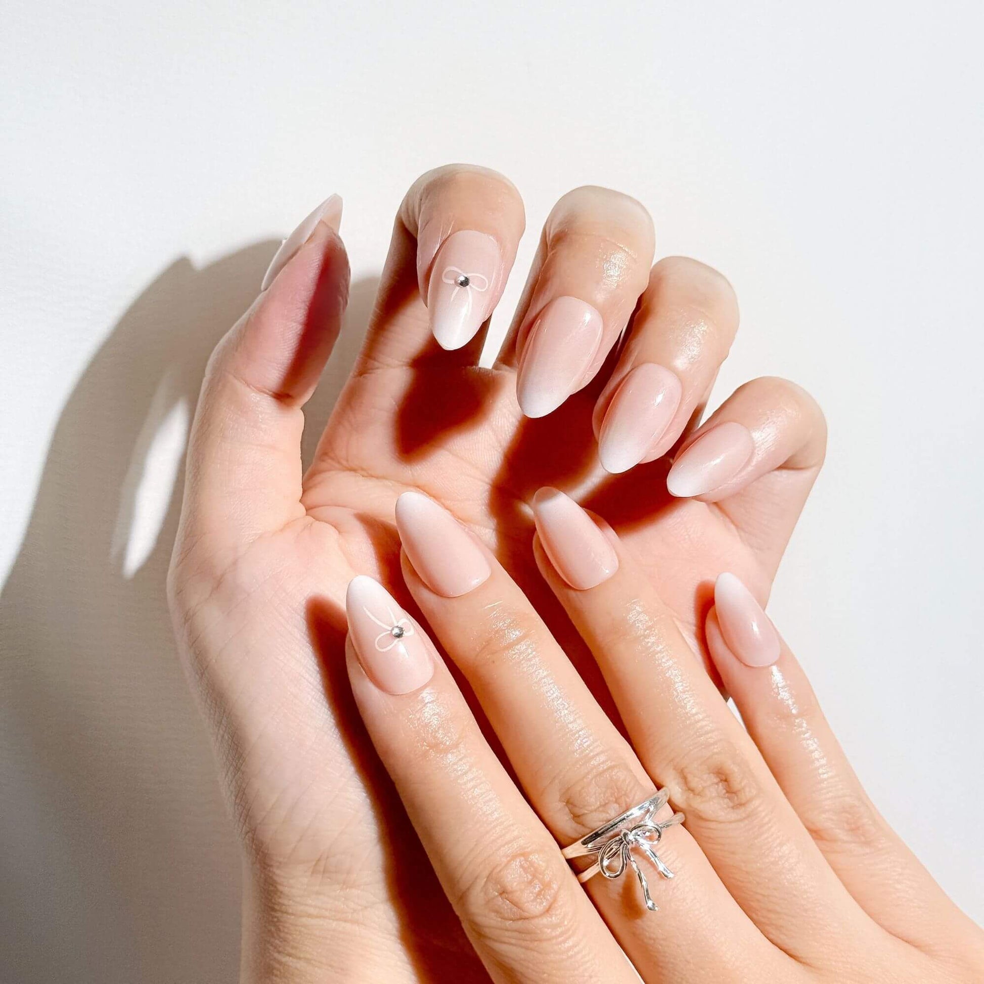 Pale Pink Ombre with Silver Bow Charm Pale Pink Ombre with Silver Bow Charm β Coquette Winter Nails