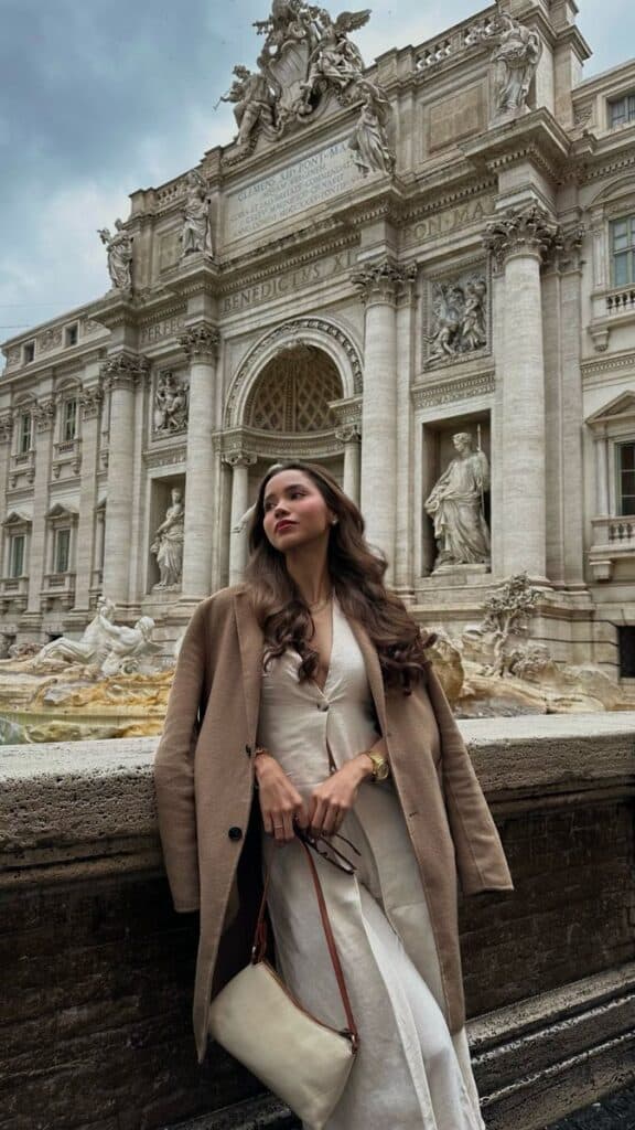 Beige Longline Wool Coat Draped Over a Linen Dress — Italy Winter Outfits