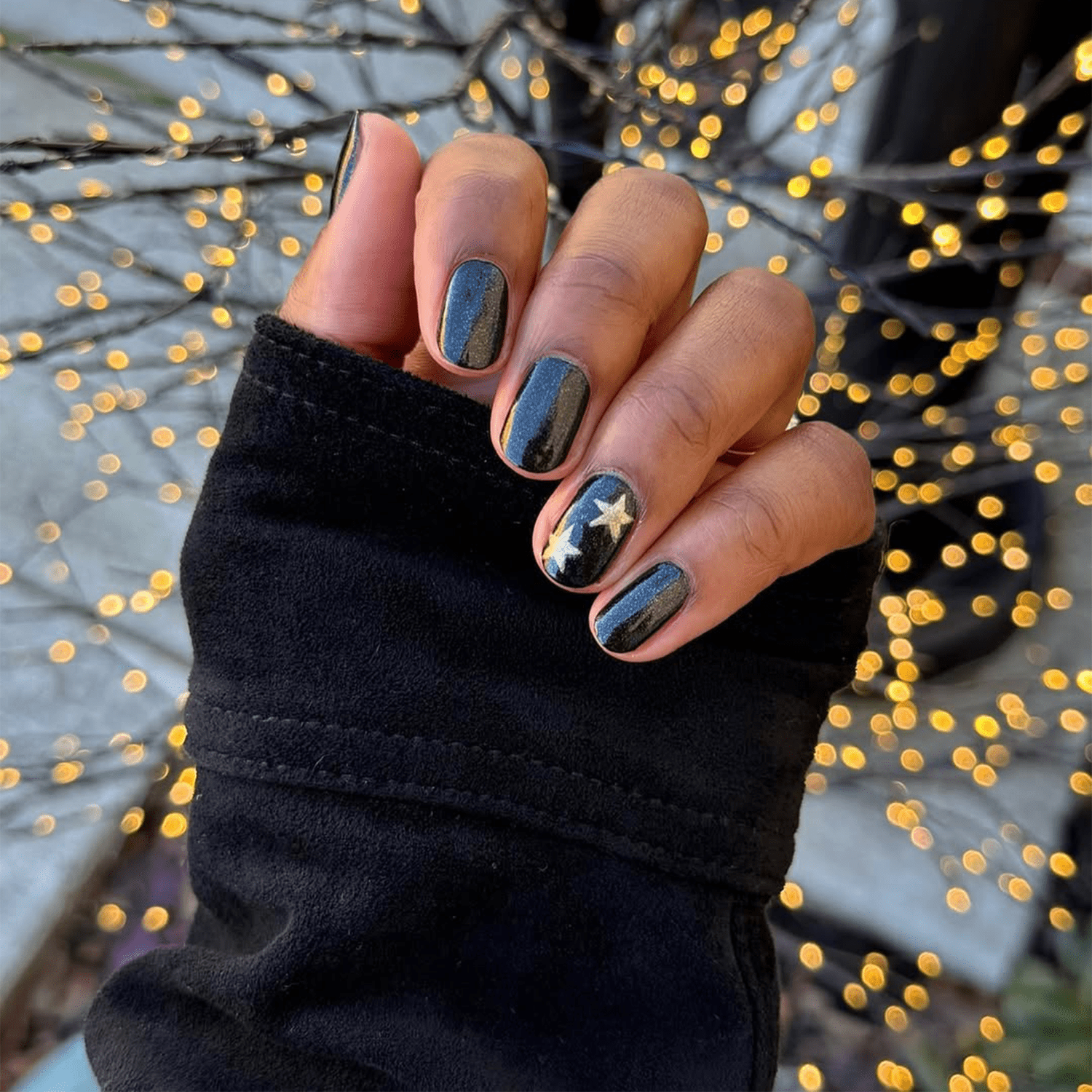 Glossy Black with Subtle Gold Star Accents — Winter Black Nails