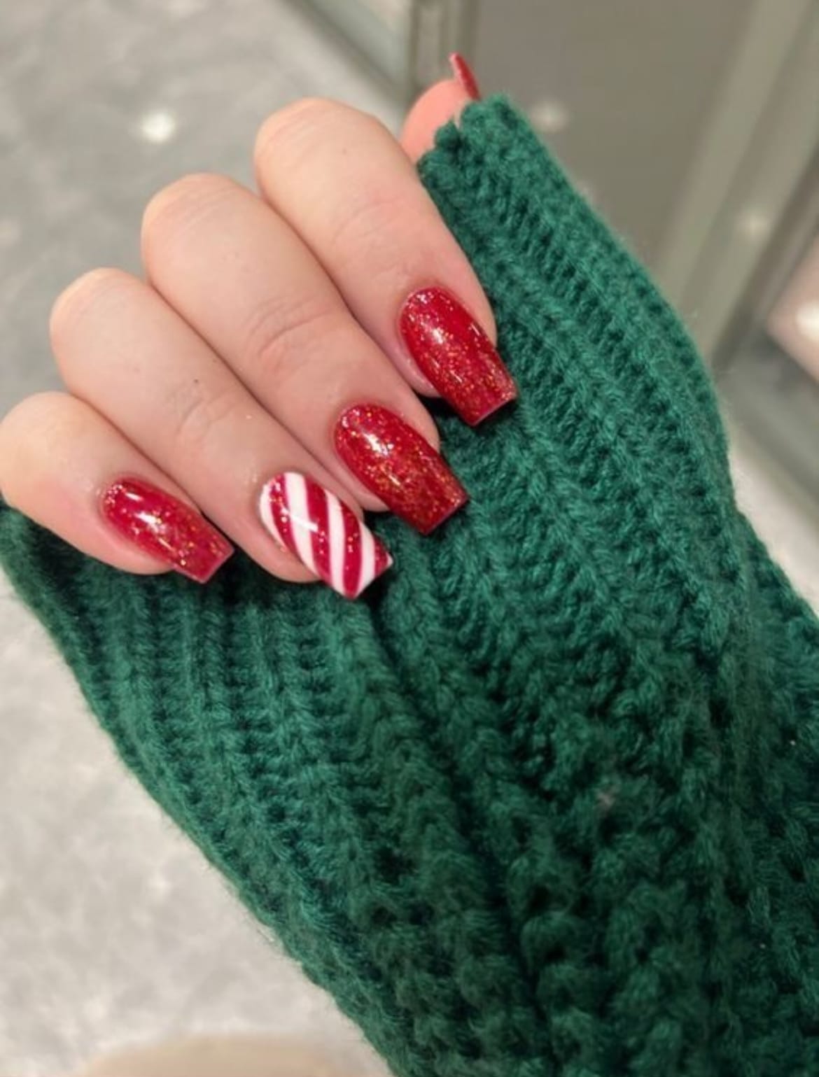 Short Square Red with Gold Glitter and Candy Cane Accent — Red Christmas Nails 2026