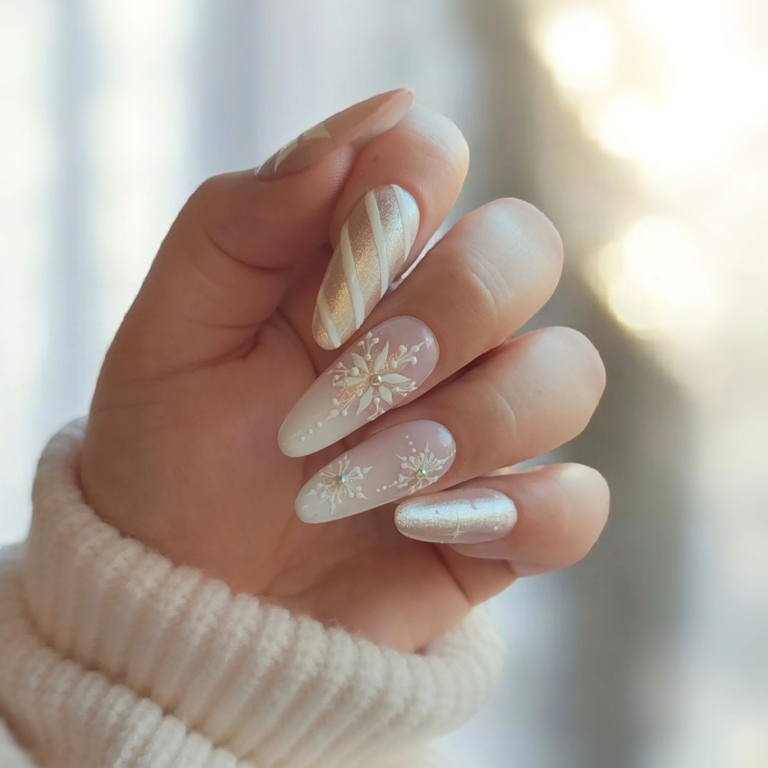 Shimmer Nude with Gold Snowflake Accents — Christmas Gel Nails 2026