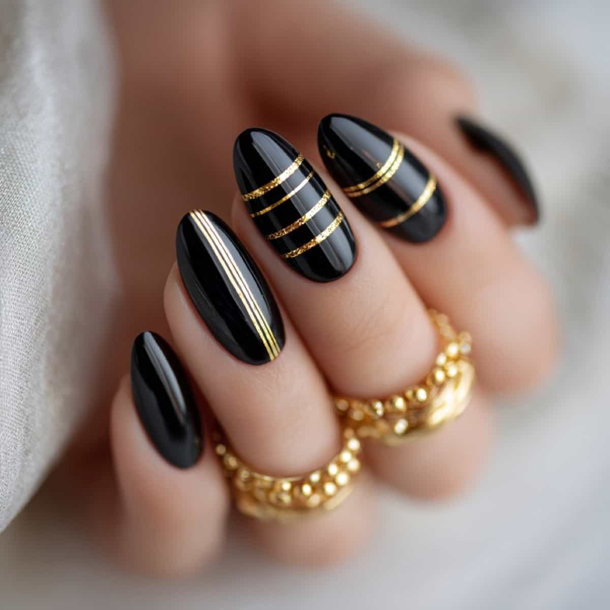 Black with Gold Stripes Black with Gold Stripes β Winter Nail Colors for Brown Skin