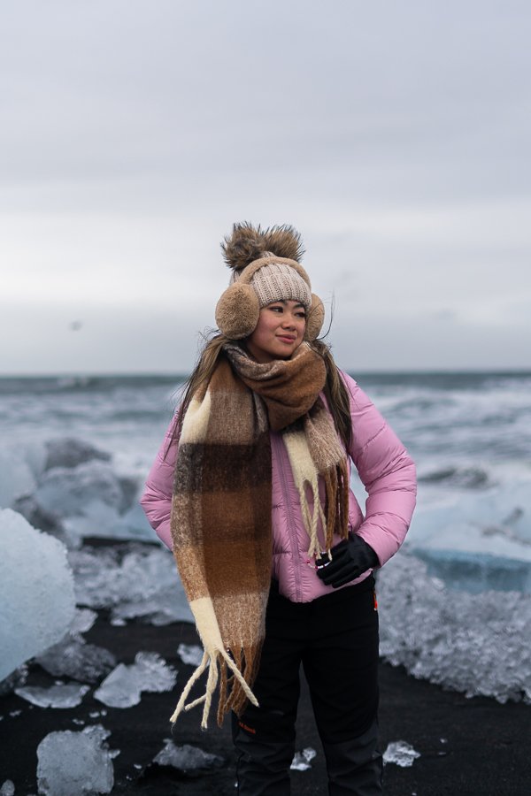 Pink Puffer Jacket Layered With A Plaid Scarf And Beige Earmuffs Pink Puffer Jacket Layered With A Plaid Scarf And Beige Earmuffs β Iceland Winter Outfits