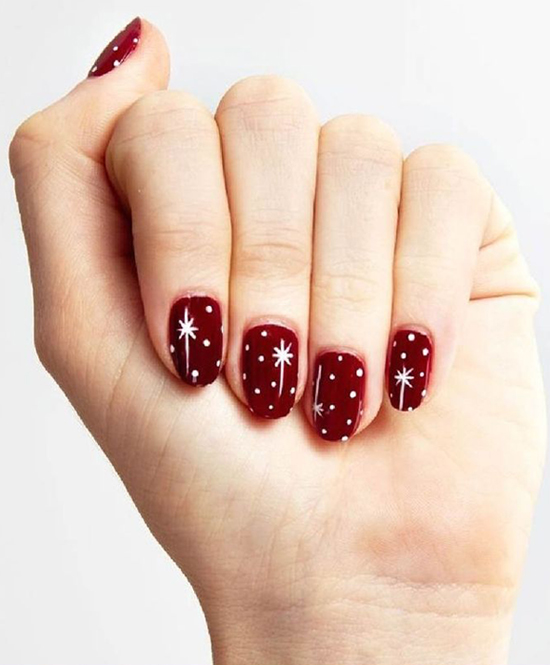 Deep Red with White Polka Dots and Starburst Accents — Red Christmas Nails 2026