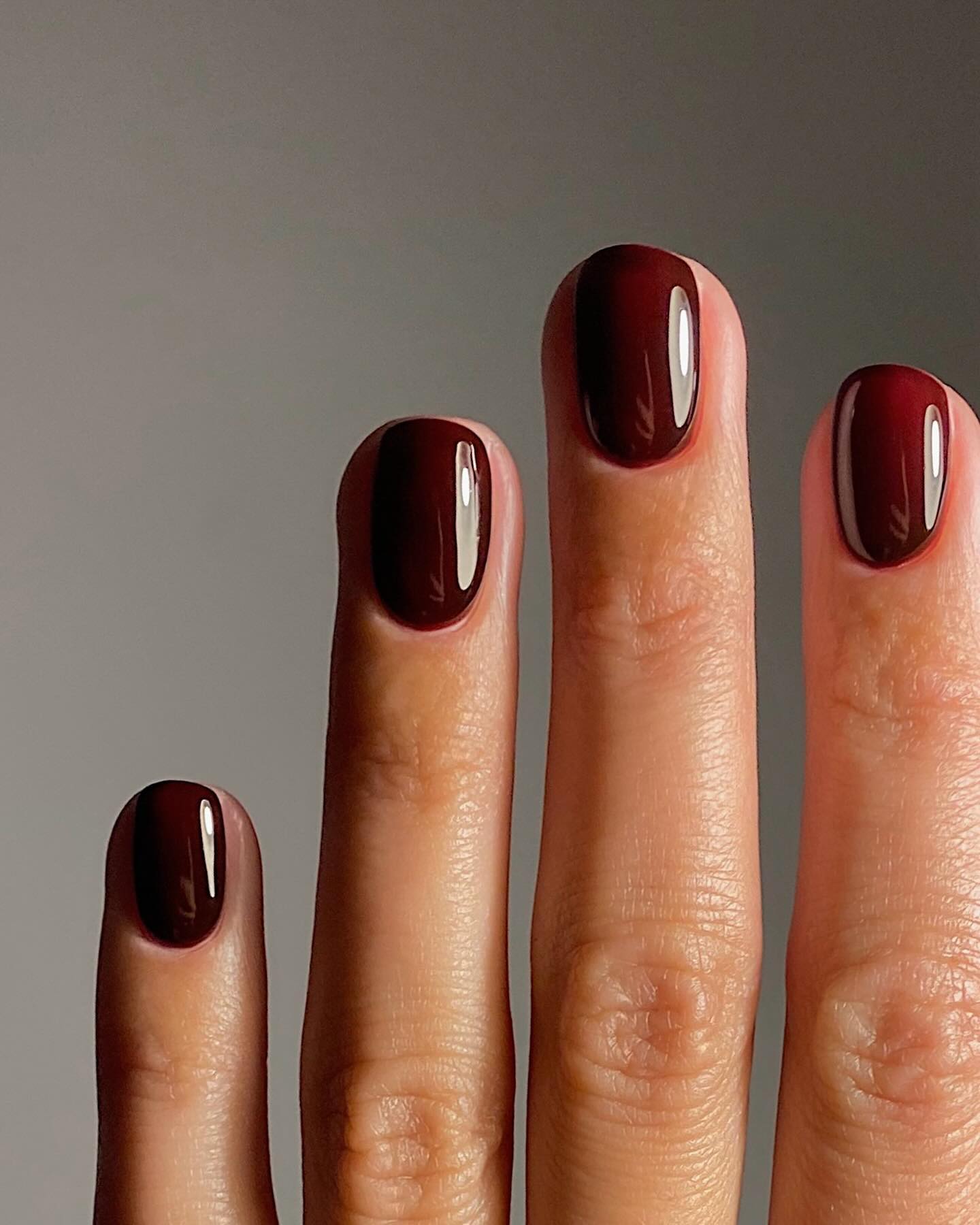 Deep Burgundy Glossy Medium Oval Nails — Winter Nail Colors for Women Over 60