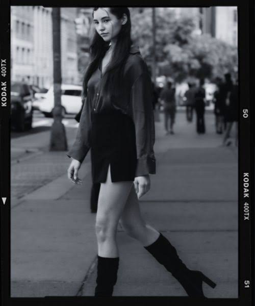 Black Leather Mini Skirt with Oversized Satin Shirt and Knee-High Boots — Leather Skirt Outfits