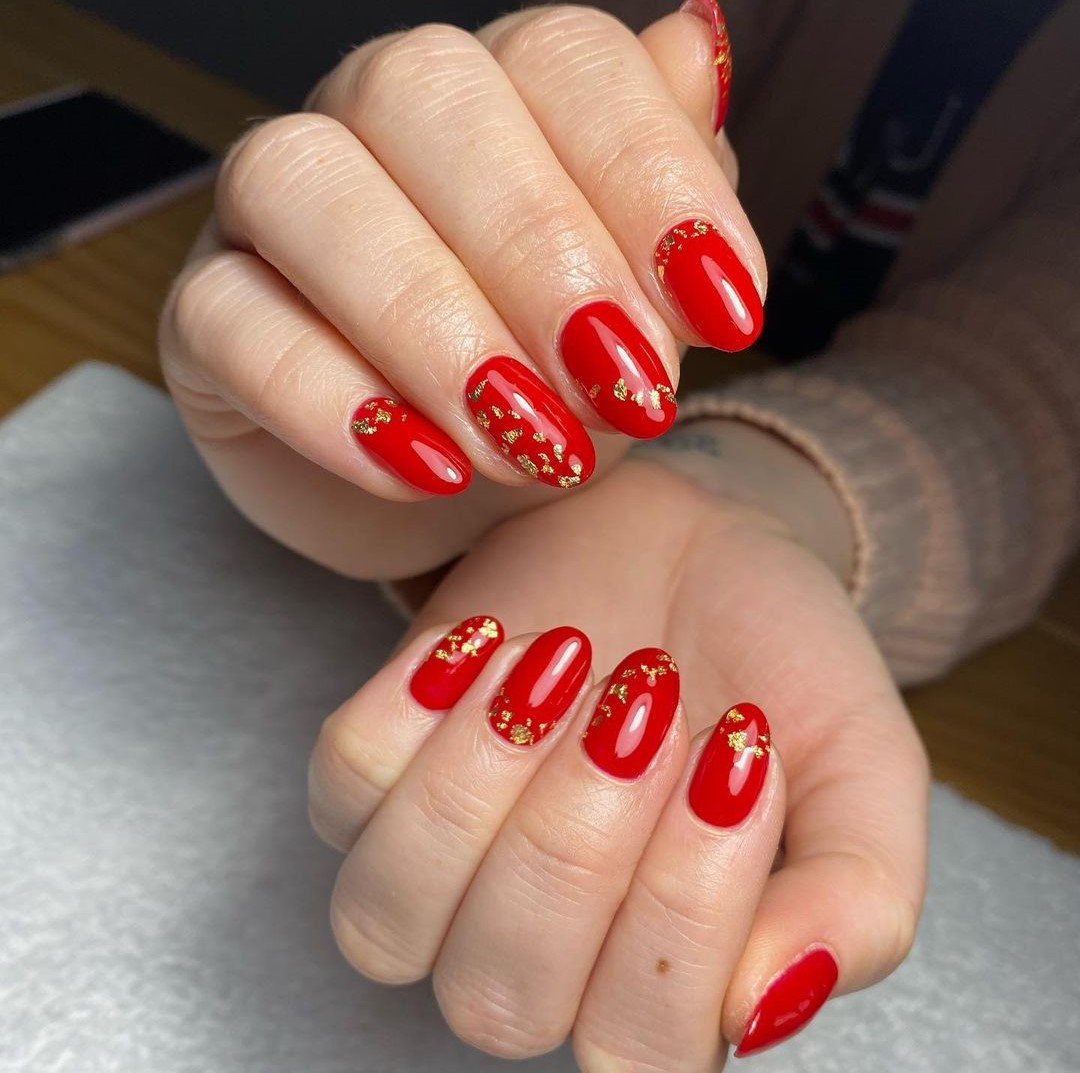 Glossy Red Nails with Gold Foil Flakes Glossy Red Nails with Gold Foil Flakes β New Years Nail Colors 2027