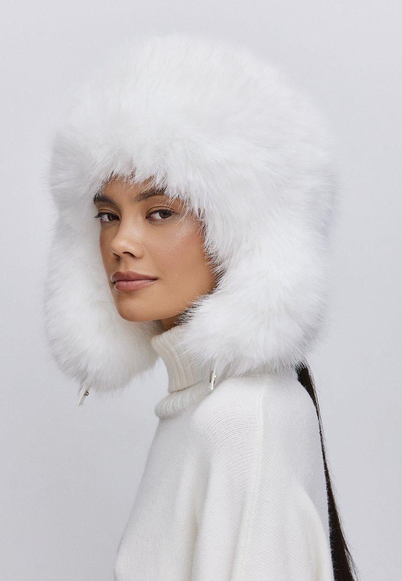 Chic White Fur Hat Paired with a Knit Turtleneck — Fur Hat Outfits
