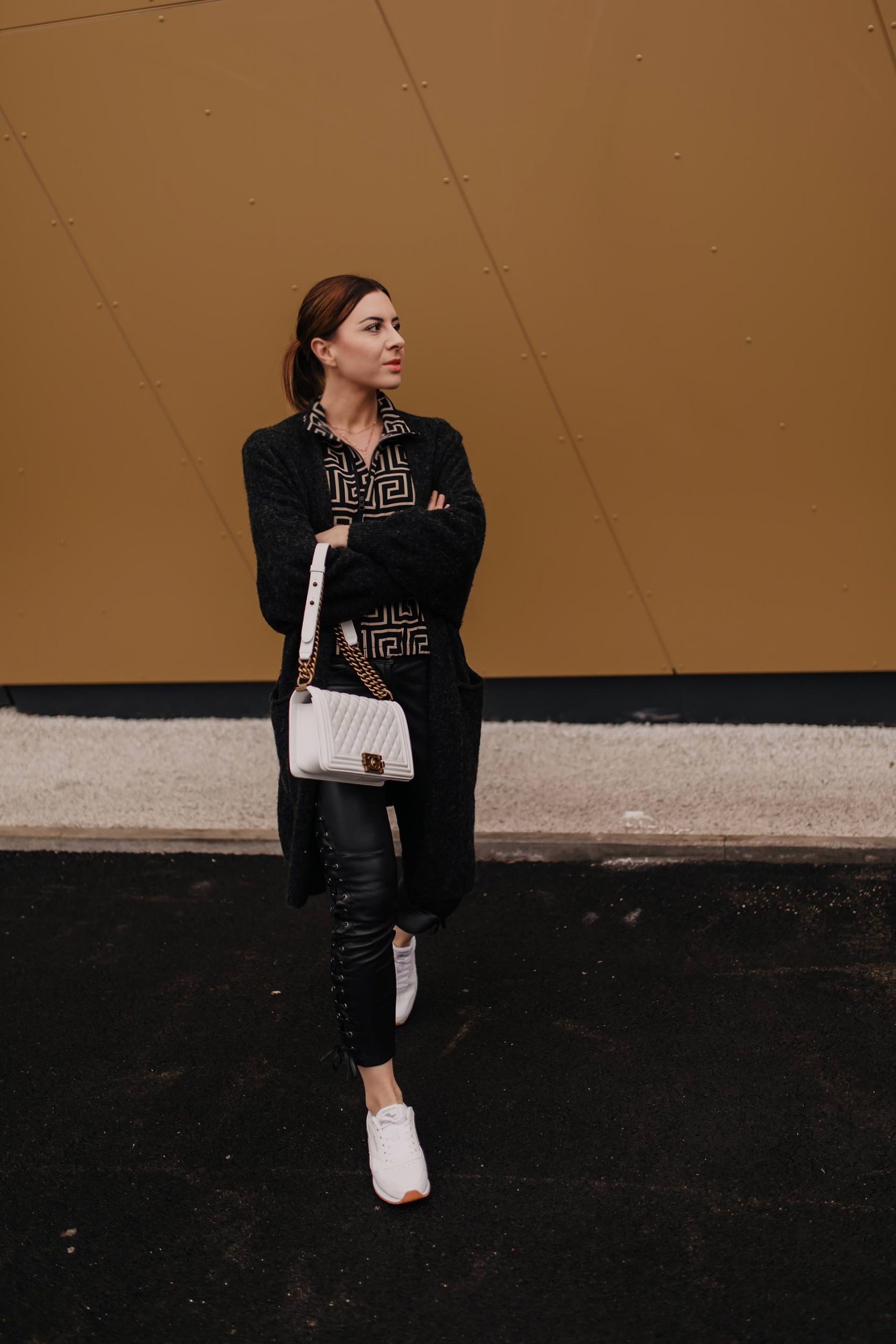 Slim Black Leather Pants with Graphic Shirt, Cardigan, and White Sneakers — Leather Pants Outfits