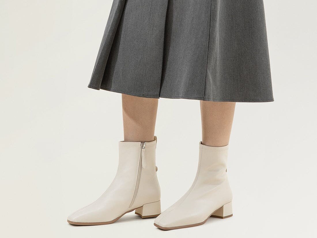 Minimalist Ensemble: Cream Boots with Grey Pleated Midi Skirt Minimalist Ensemble: Cream Boots with Grey Pleated Midi Skirt β Ankle Boots Outfits
