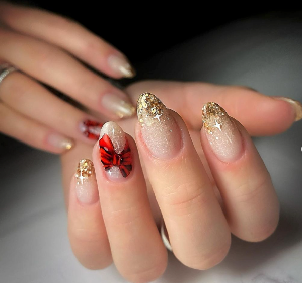 Nude Base with Gold Glitter and Red Bow Nude Base with Gold Glitter and Red Bow β Christmas Almond Nails 2026