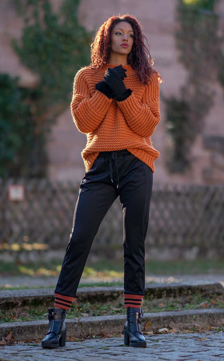 Casual Comfort: Vibrant Orange Sweater with Track Pants — Late Winter Outfits