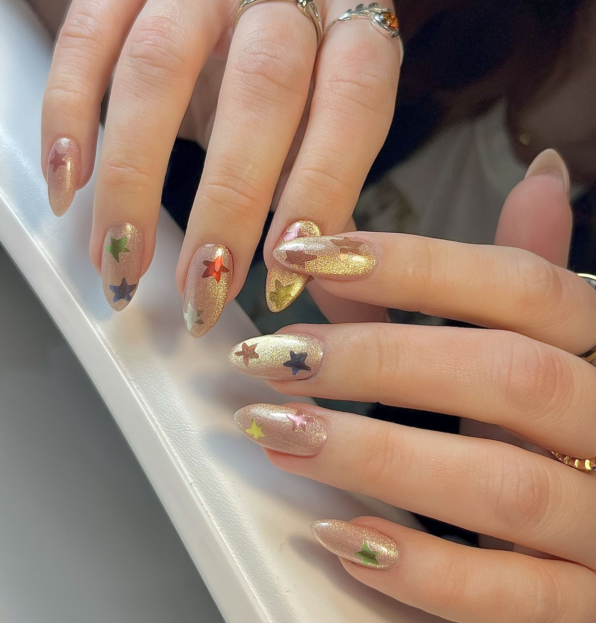 Long Almond Champagne Foil Star Accents Long Almond Champagne Foil Star Accents β New Years Nails 2027
