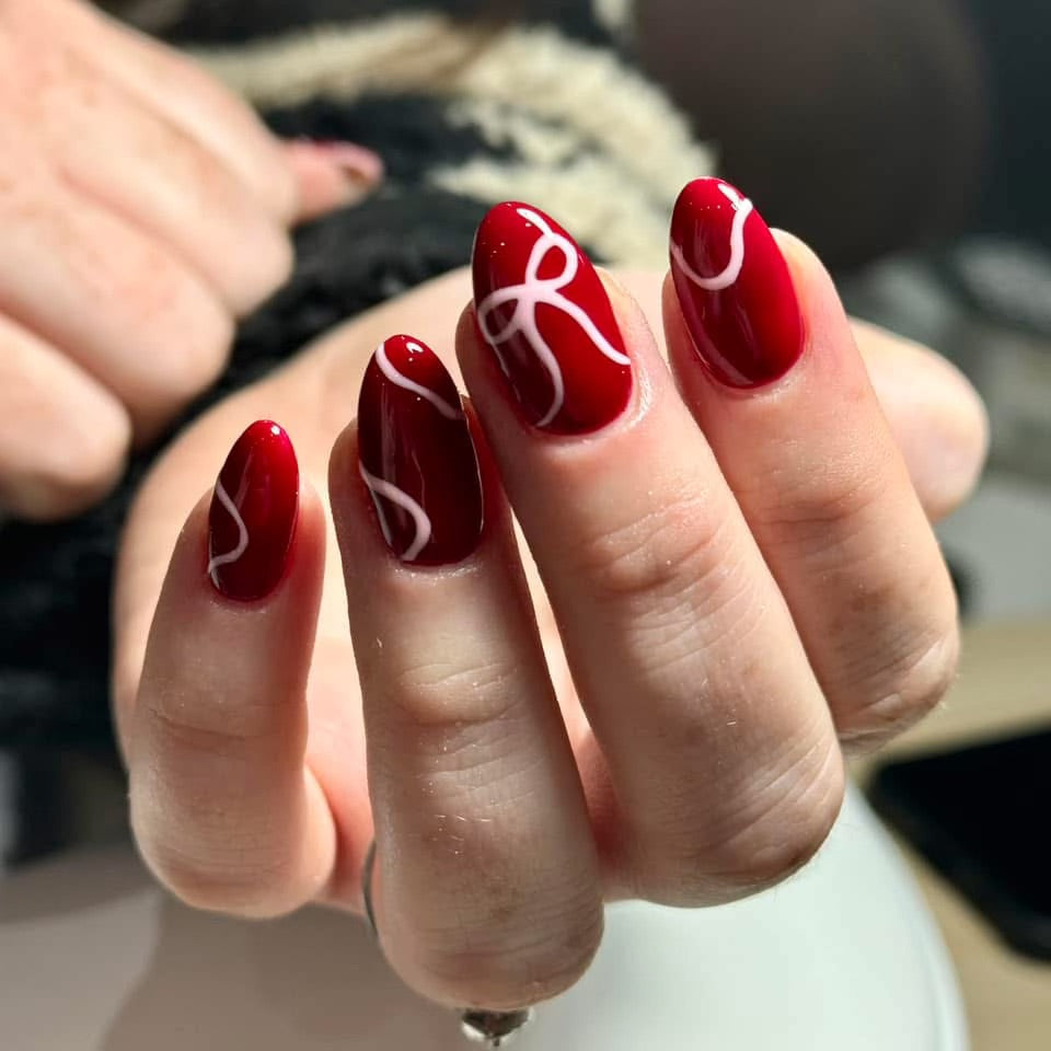 Thin White Swirling Lines And Small Bows Visual Idea Thin White Swirling Lines And Small Bows Visual Idea β Christmas Nails 2026